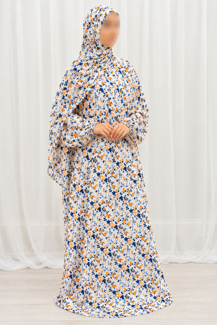 Side profile of Amani's eggshell white and orange floral prayer dress with attached hijab and sleeves hanging naturally, no lace