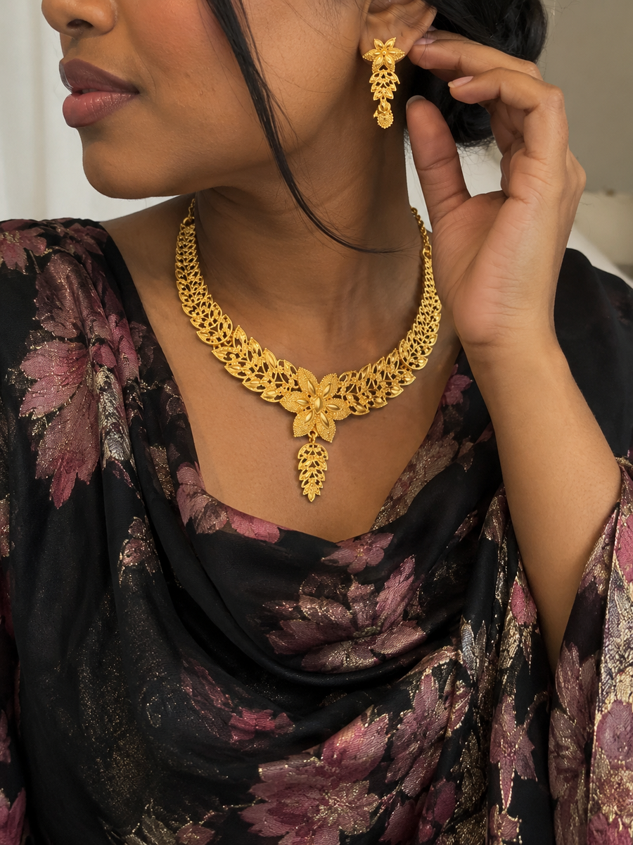 Model wearing Amani's golden blossom leaf necklace and matching earrings