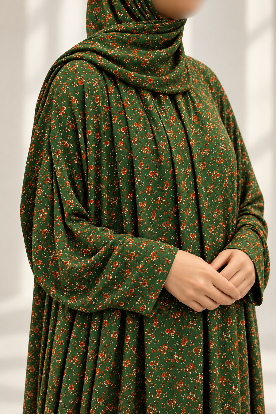 Moss green floral stretch jersey prayer dress, close-up of fabric and plain sleeve opening