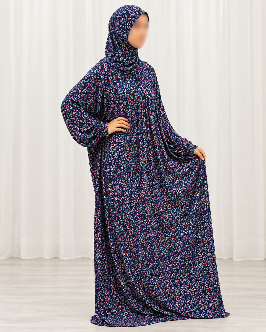 Amani's navy mini floral one piece prayer dress with attached hijab, side profile showing the full-length drape and plain sleeves