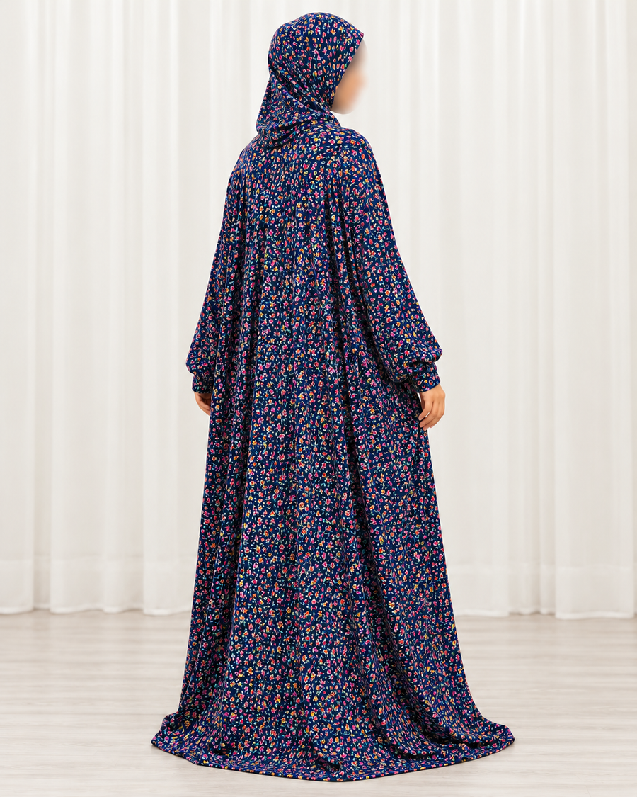 Amani's navy mini floral prayer dress without lace, alternate three-quarter pose showing floral print, attached hijab and sleeves down