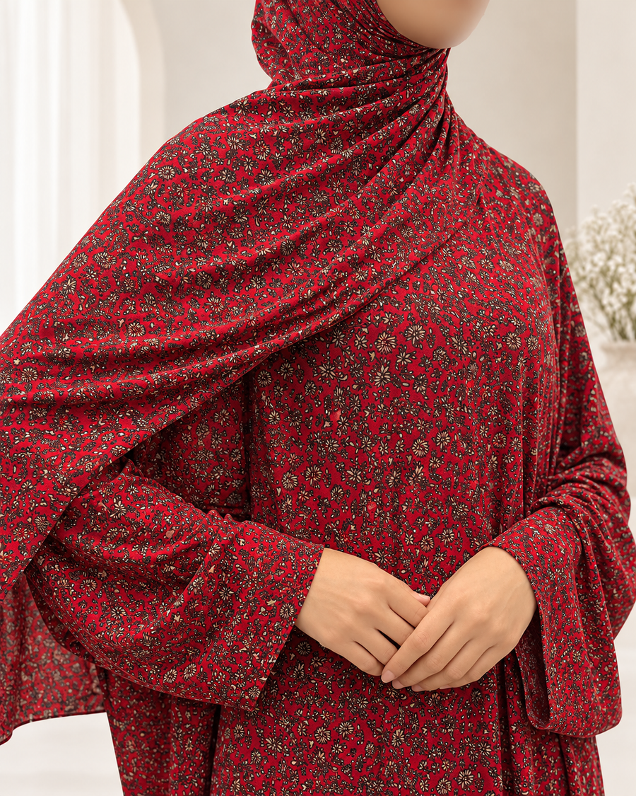 Close-up of red floral jersey prayer dress showing tiny black and cream flowers and plain lace-free sleeves