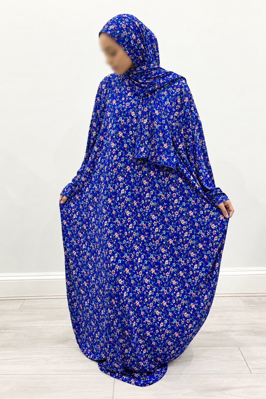 Amani's royal blue pink blossom floral one-piece prayer dress, front view with attached wrap-around hijab and no lace