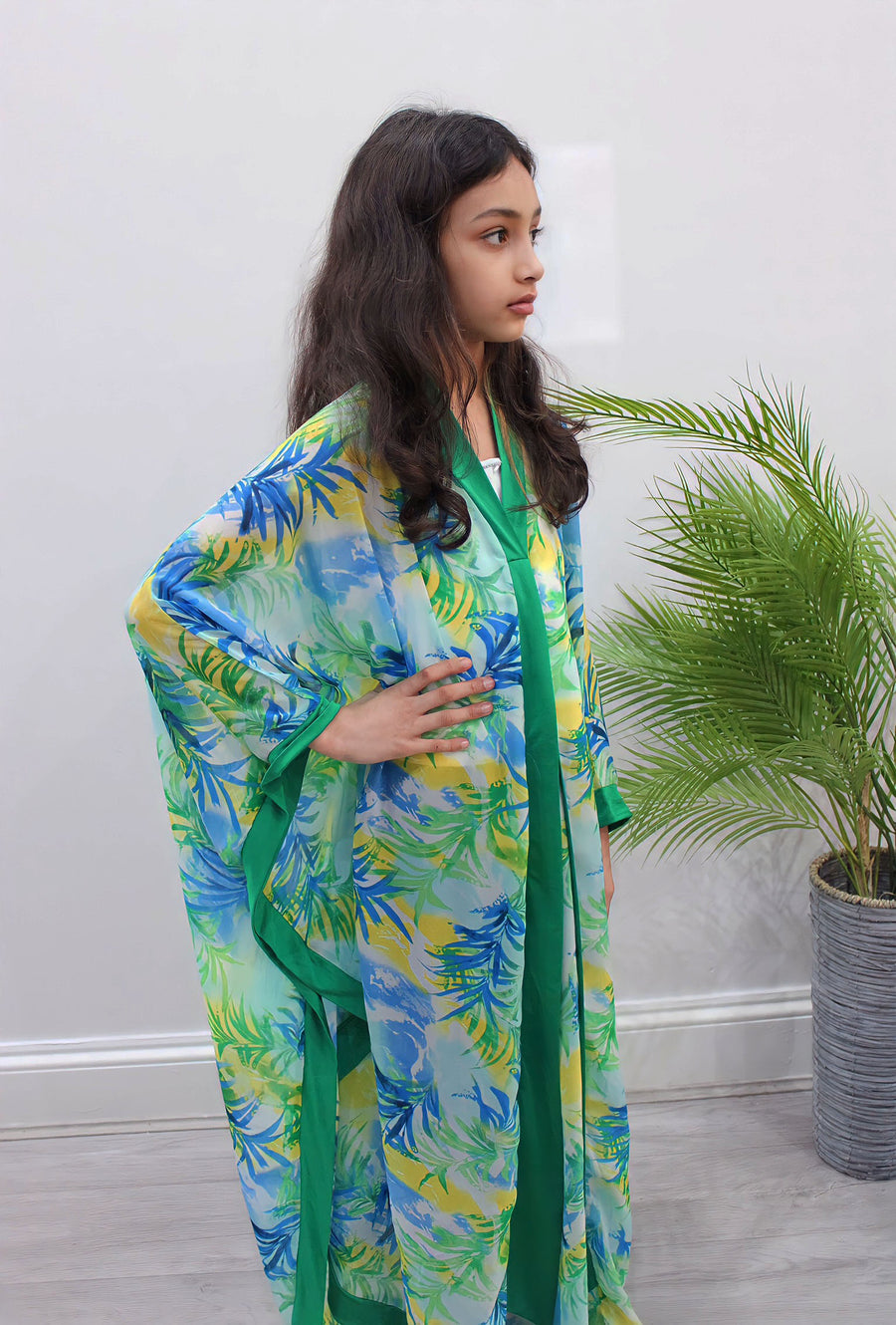 Close-up of the green palm-leaf chiffon print on the kids kaftan