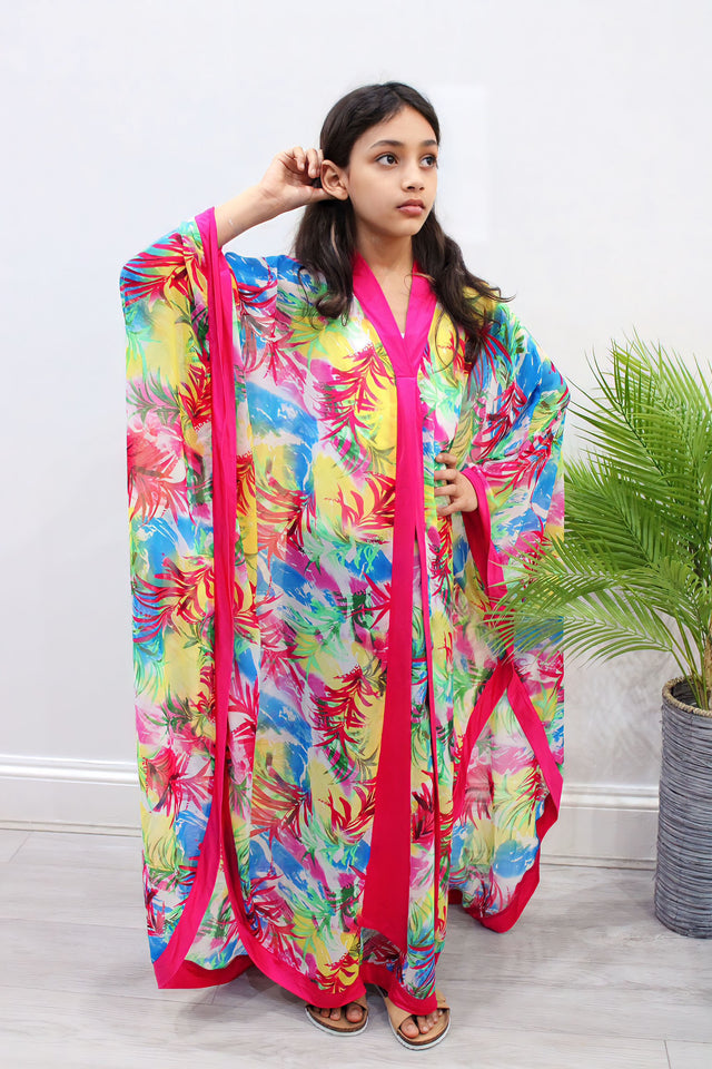 Girl wearing Amani's fuchsia floral chiffon kids kaftan over an undergarment