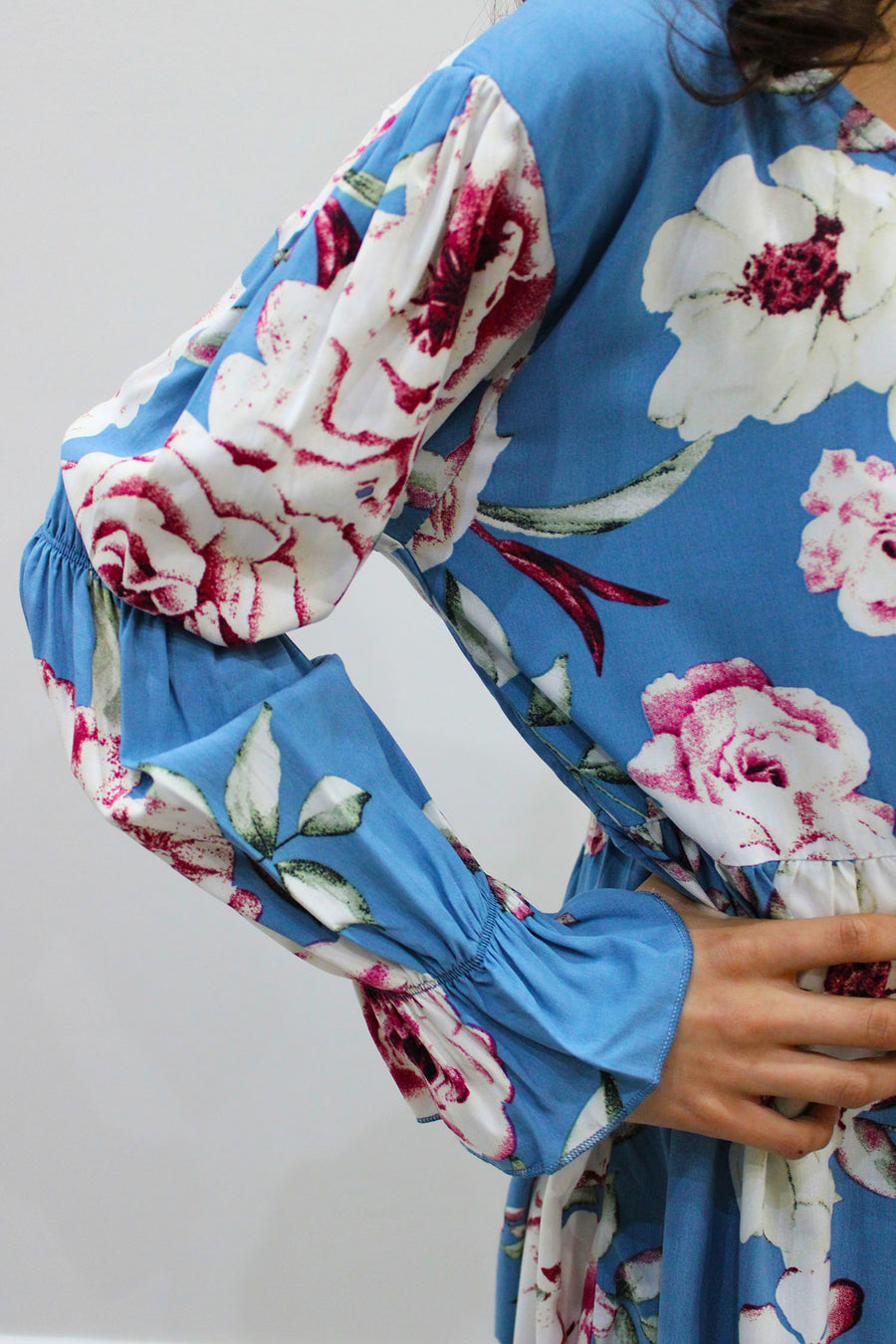 Full-length view of Amani's powder blue puff-sleeve tiered dress