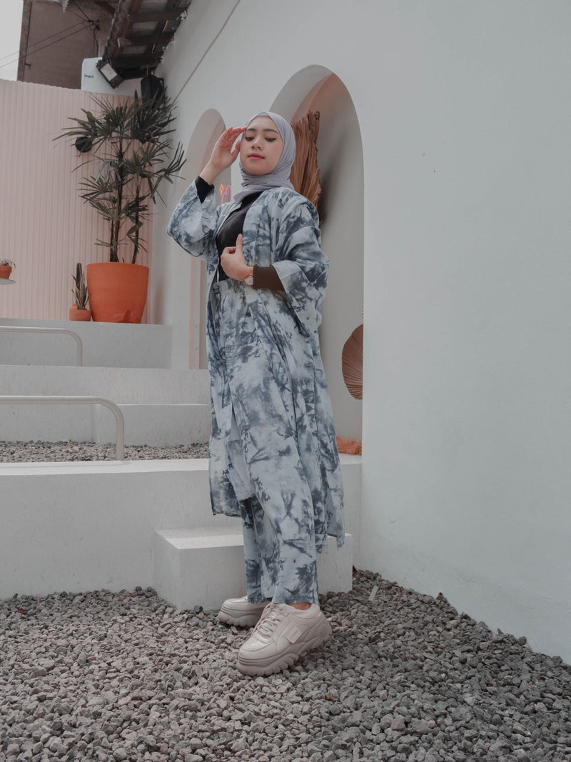 Full-length Muslim woman wearing a layered modest outfit and hijab outdoors, illustrating modest fashion length, proportion and movement