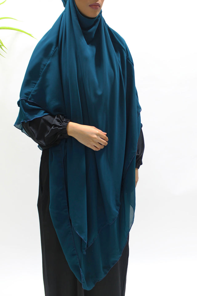 Rich teal two-layer diamond chiffon khimar shown from the front with full chest coverage