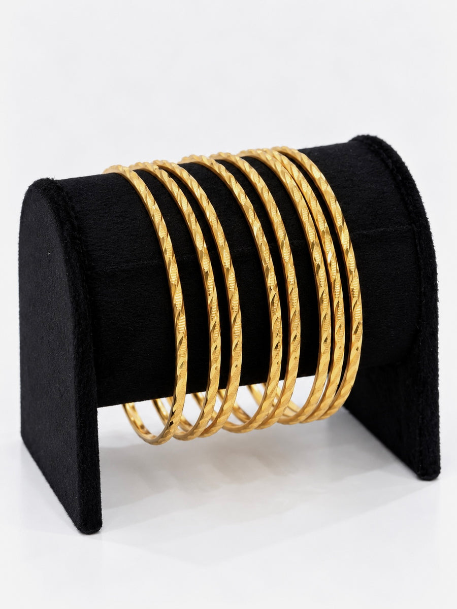 24K gold plated set of 8 textured bangles on black jewellery stand