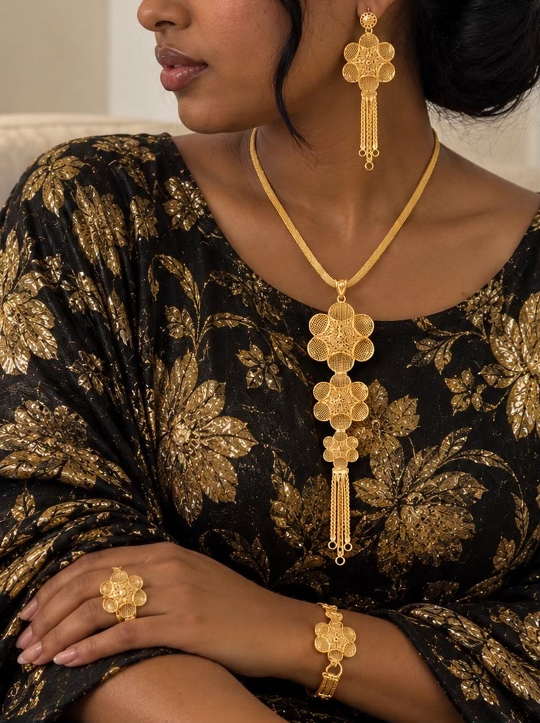 Woman wearing 24K gold-plated floral filigree necklace earrings bracelet and ring
