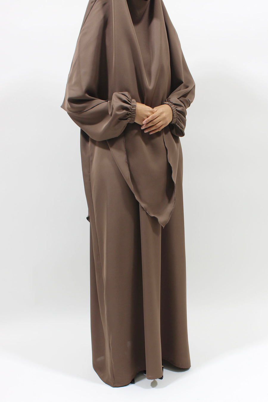 Dark beige overhead abaya showing the loose fit and Neda drape