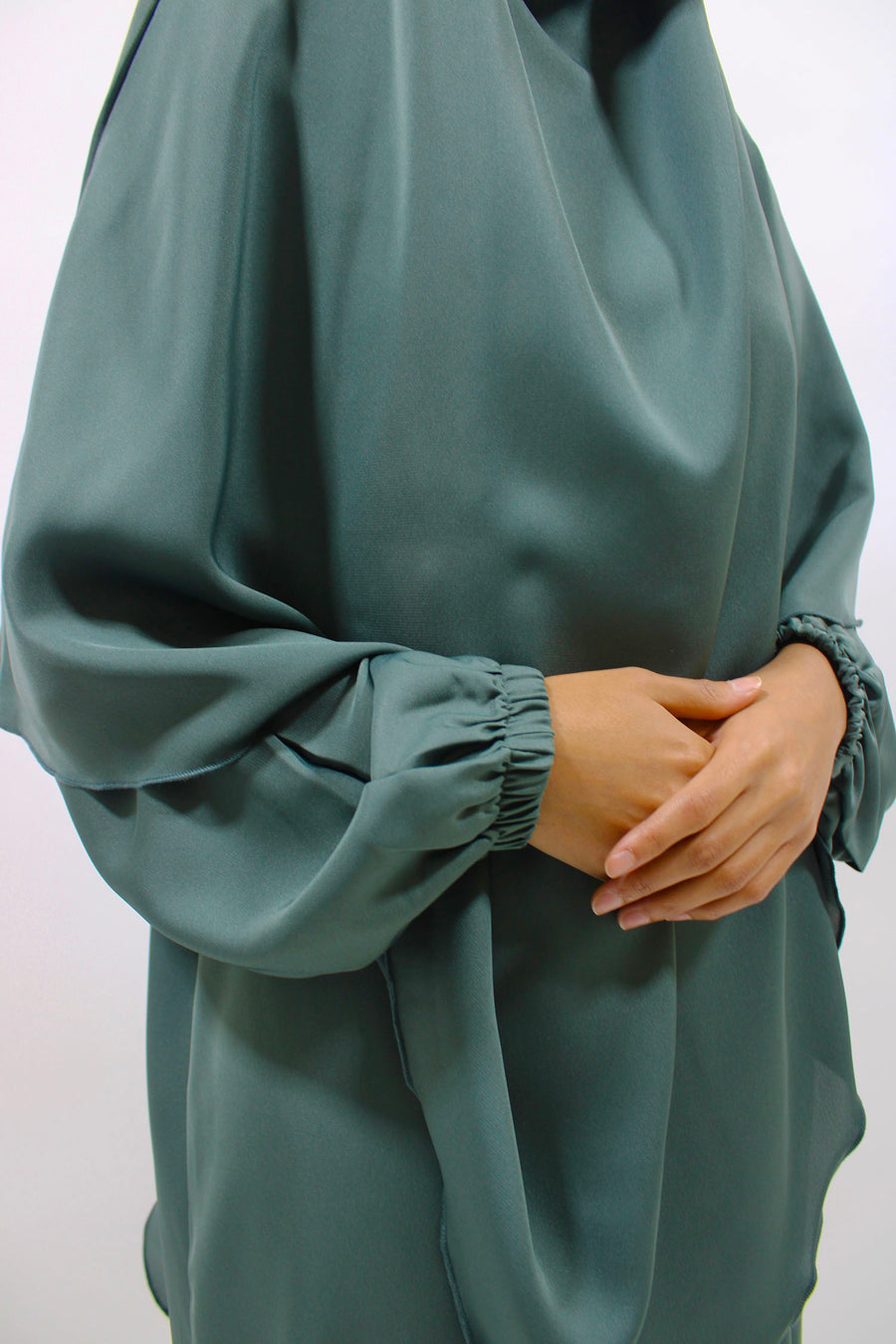 Pine green overhead abaya showing the loose fit and Neda drape