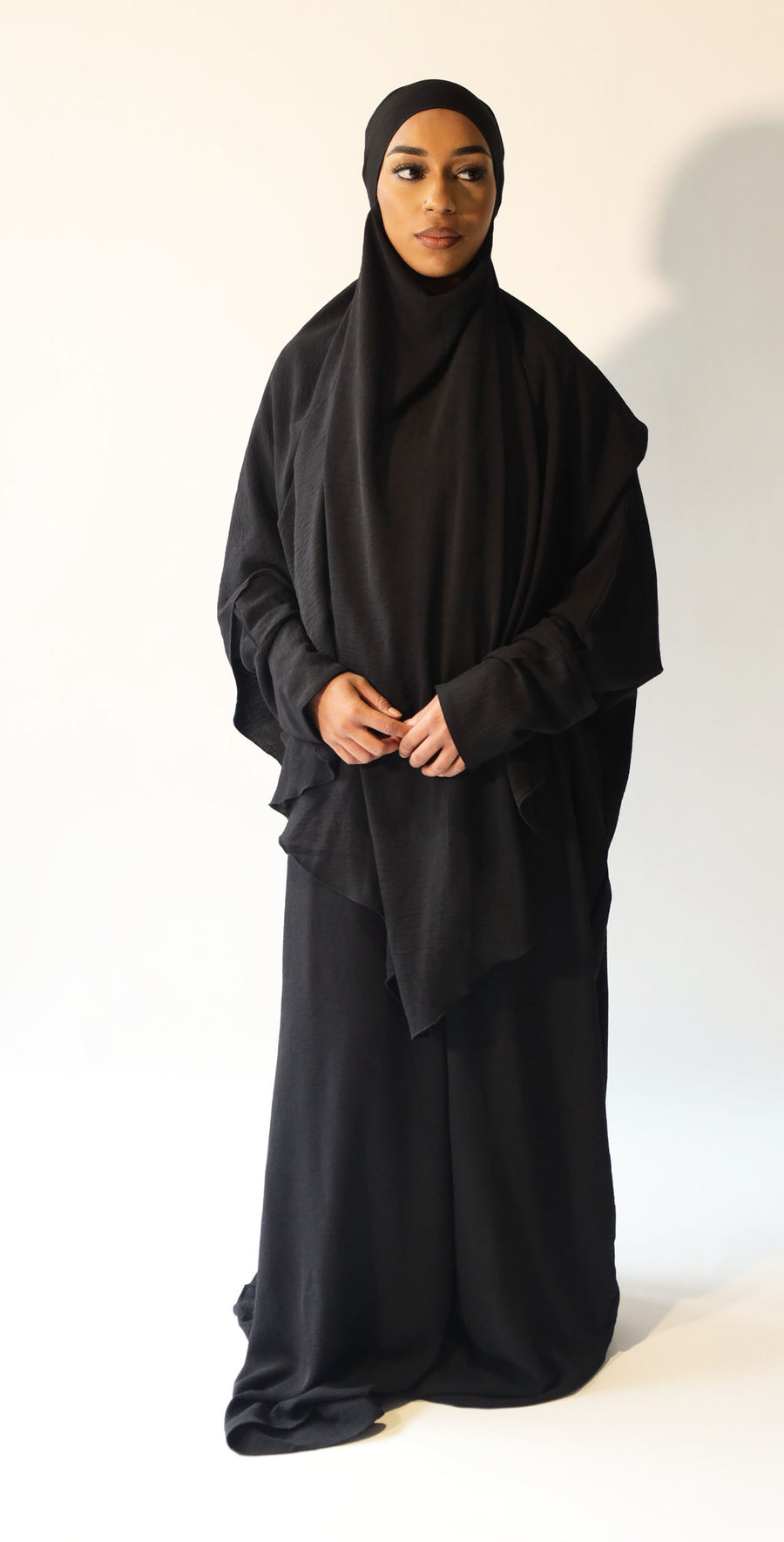 Black overhead abaya showing the loose fit and crepe drape