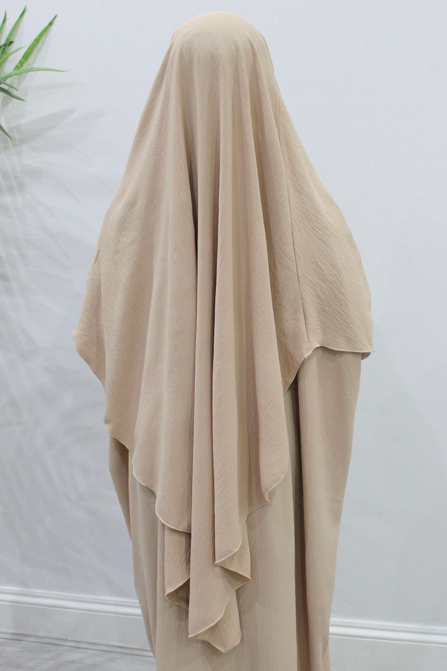 Buff overhead abaya showing the loose fit and soft crepe drape