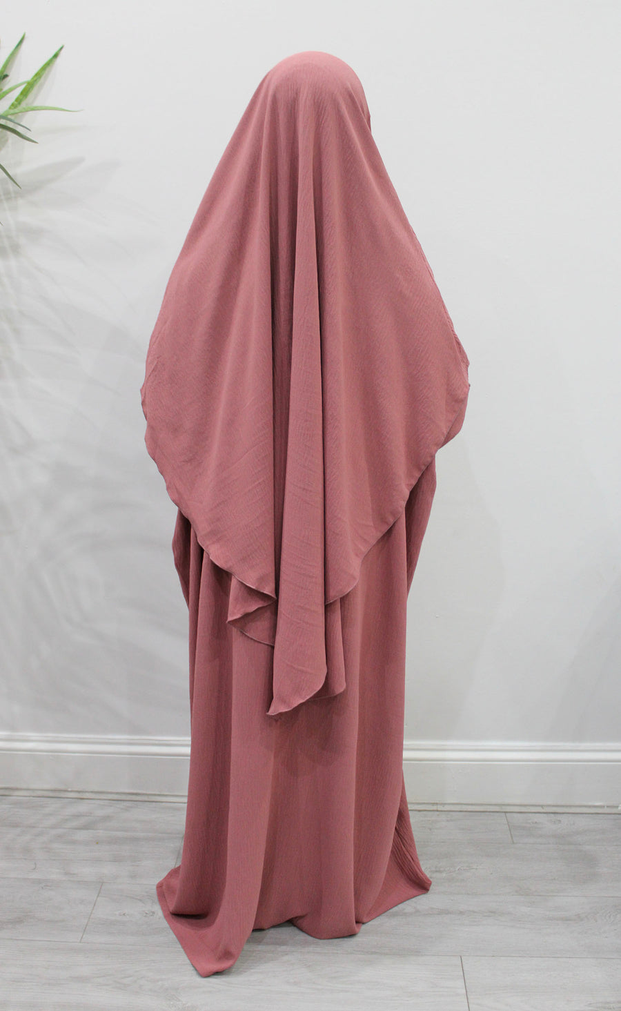 Coral overhead abaya showing the loose fit and crepe drape