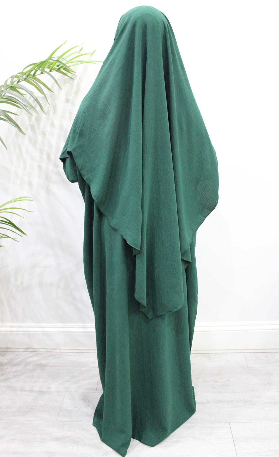 Forest green overhead abaya showing the loose fit and crepe drape