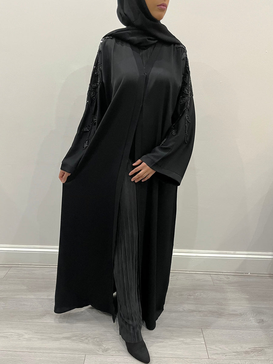 Black leaf embellished abaya shown with its matching hijab and belt