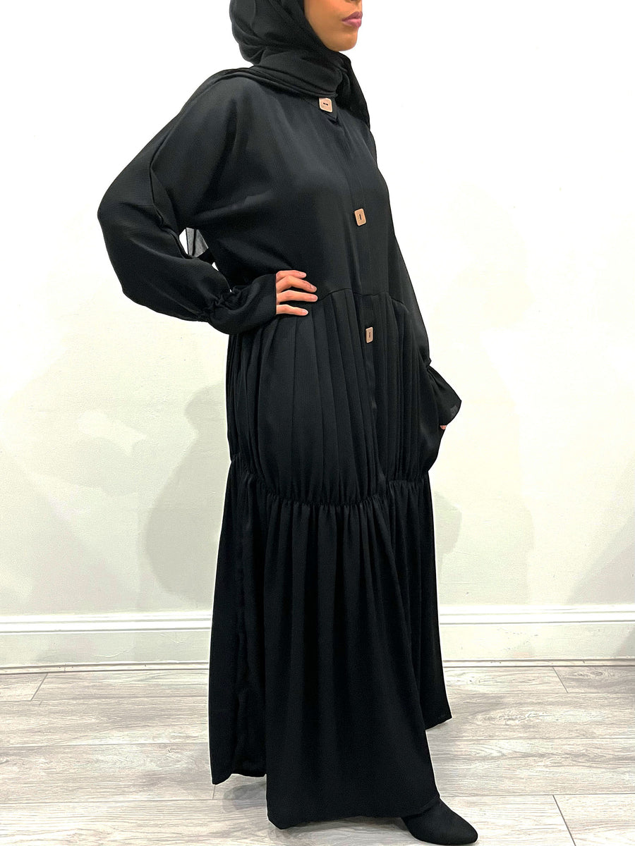 Detail of the large statement buttons on the black pleated abaya