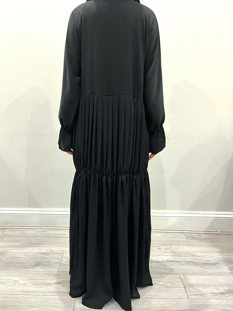 Black pleated abaya shown with its matching hijab and belt