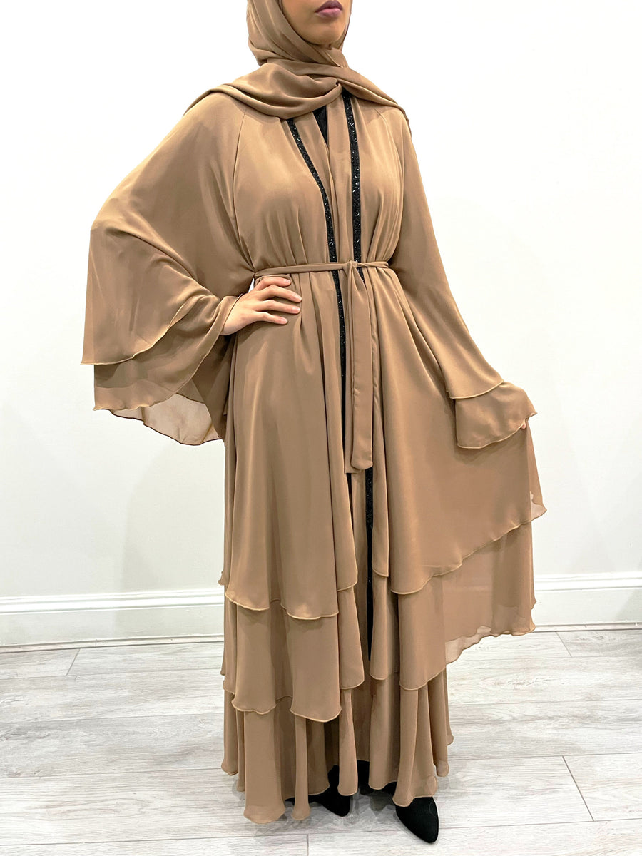 Caramel chiffon abaya belted at the waist showing the layered drape