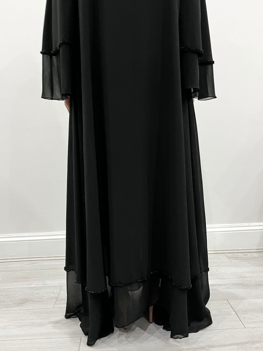 Close-up of black crystal embellishments on the chiffon abaya