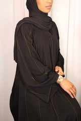 Amani's closed abaya with burnt orange piping, front view