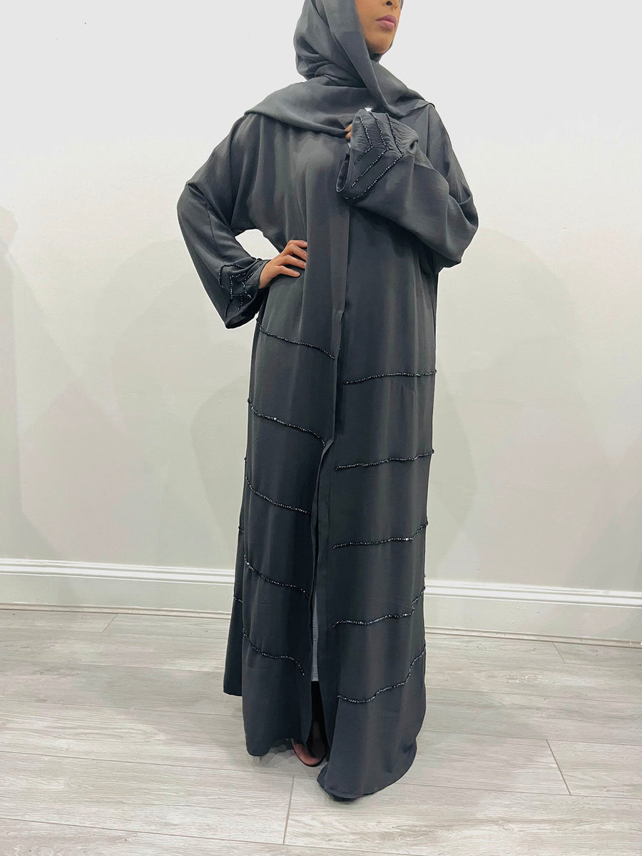 Charcoal grey open abaya belted over its inner slip dress