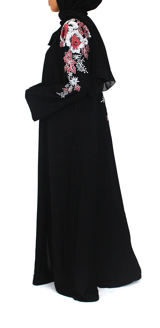 Close-up of the floral embroidery detail on the black abaya