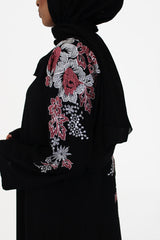 Black abaya with floral embroidery on the shoulders and sleeves, front view