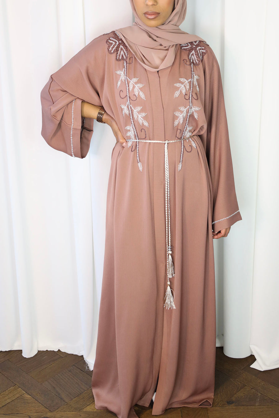 French rose abaya belted at the waist showing the textured crepe drape