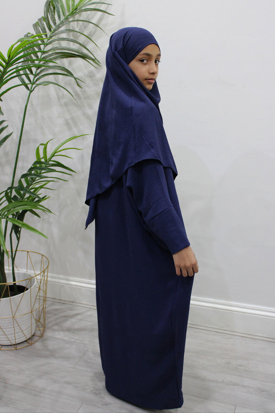 Girl wearing Amani's navy abaya and khimar set, front view