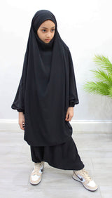 Girl wearing Amani's black two-piece sarouel jilbab with half-jilbab top and harem trousers