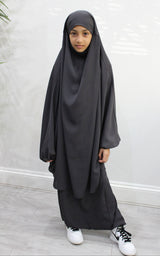 Girl wearing Amani's dark grey two-piece sarouel jilbab set