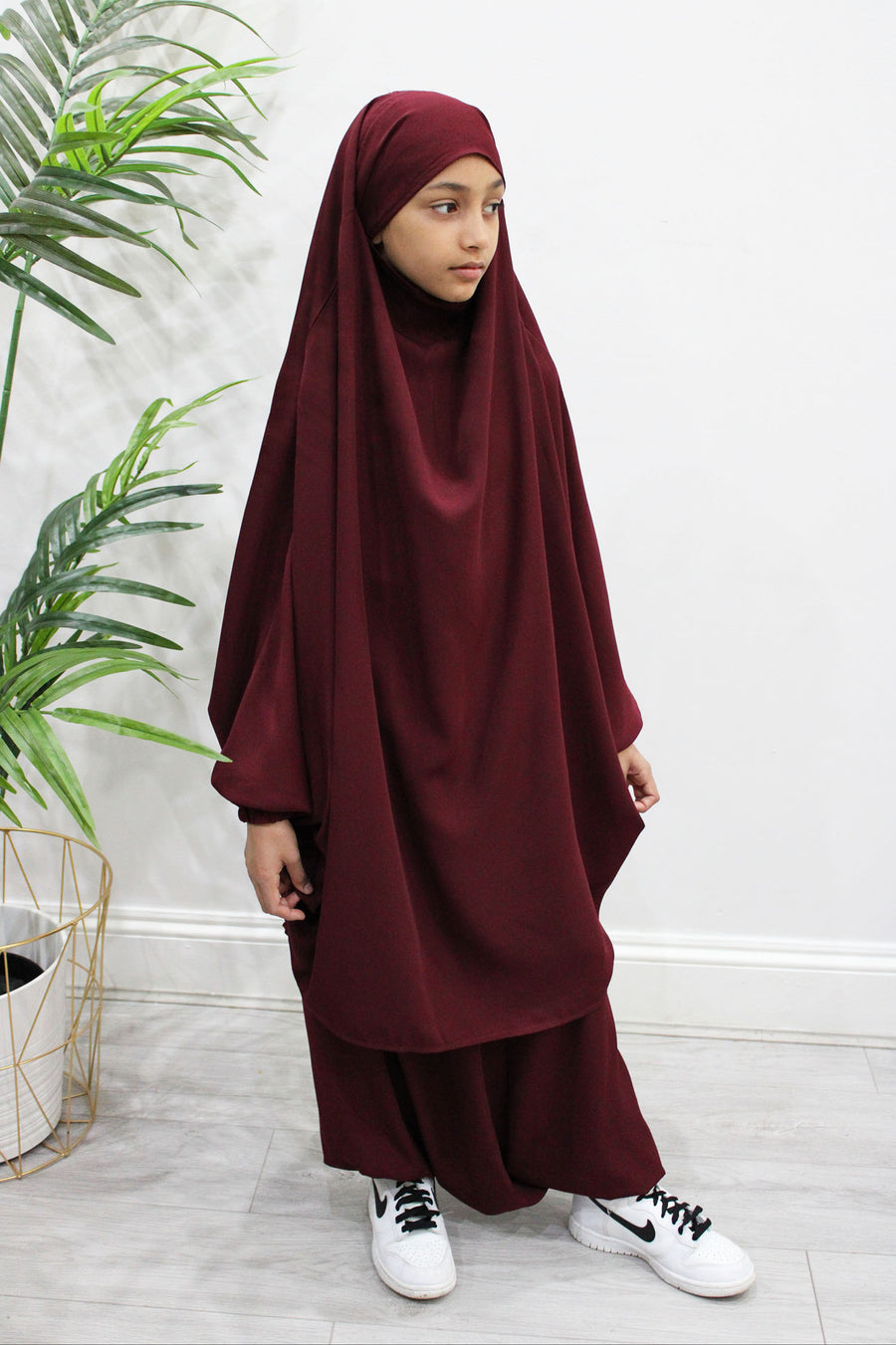 Girl wearing Amani's maroon two-piece sarouel jilbab set