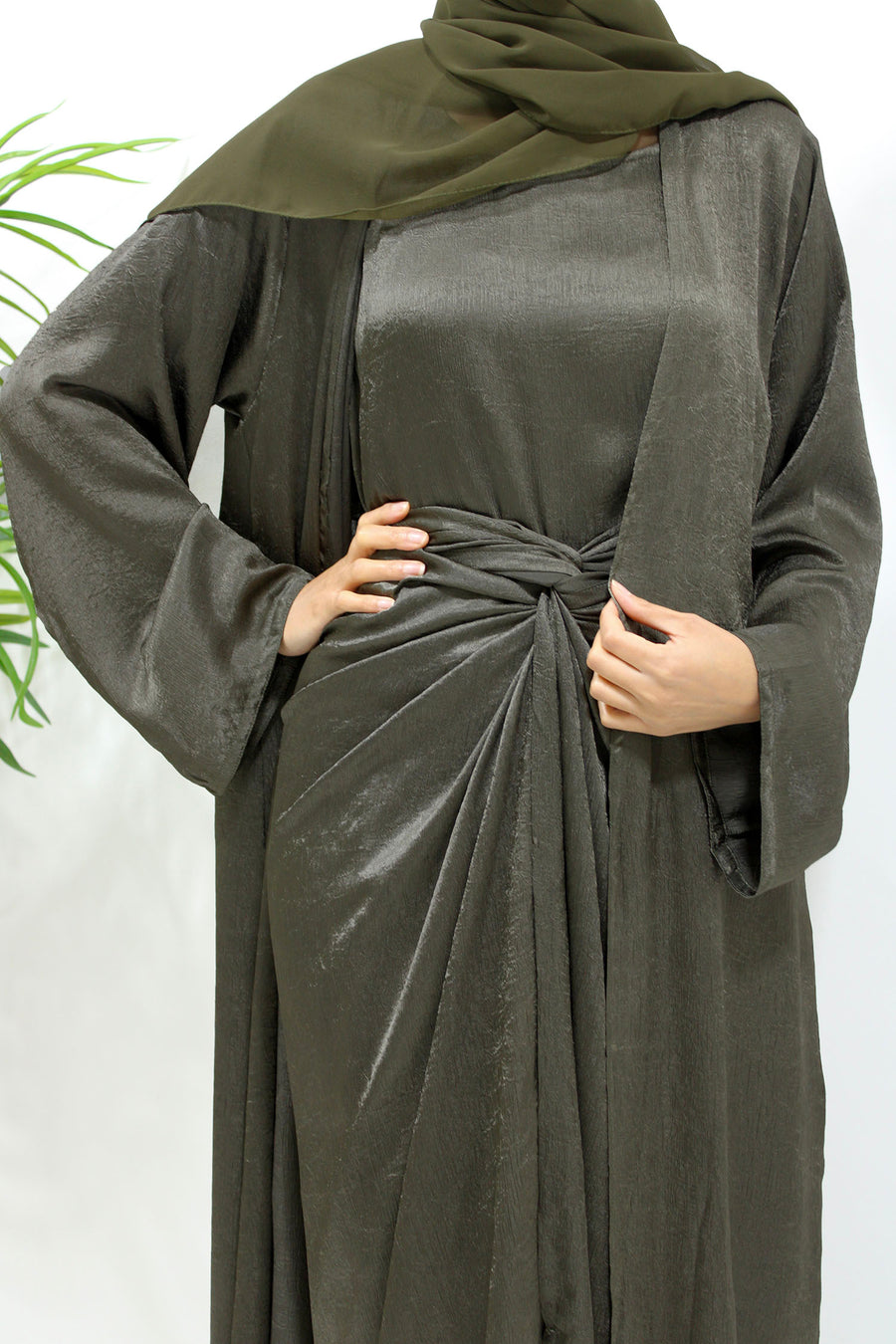 Army green crushed satin four-piece open abaya set shown front-on with kimono abaya, inner dress and wrap skirt
