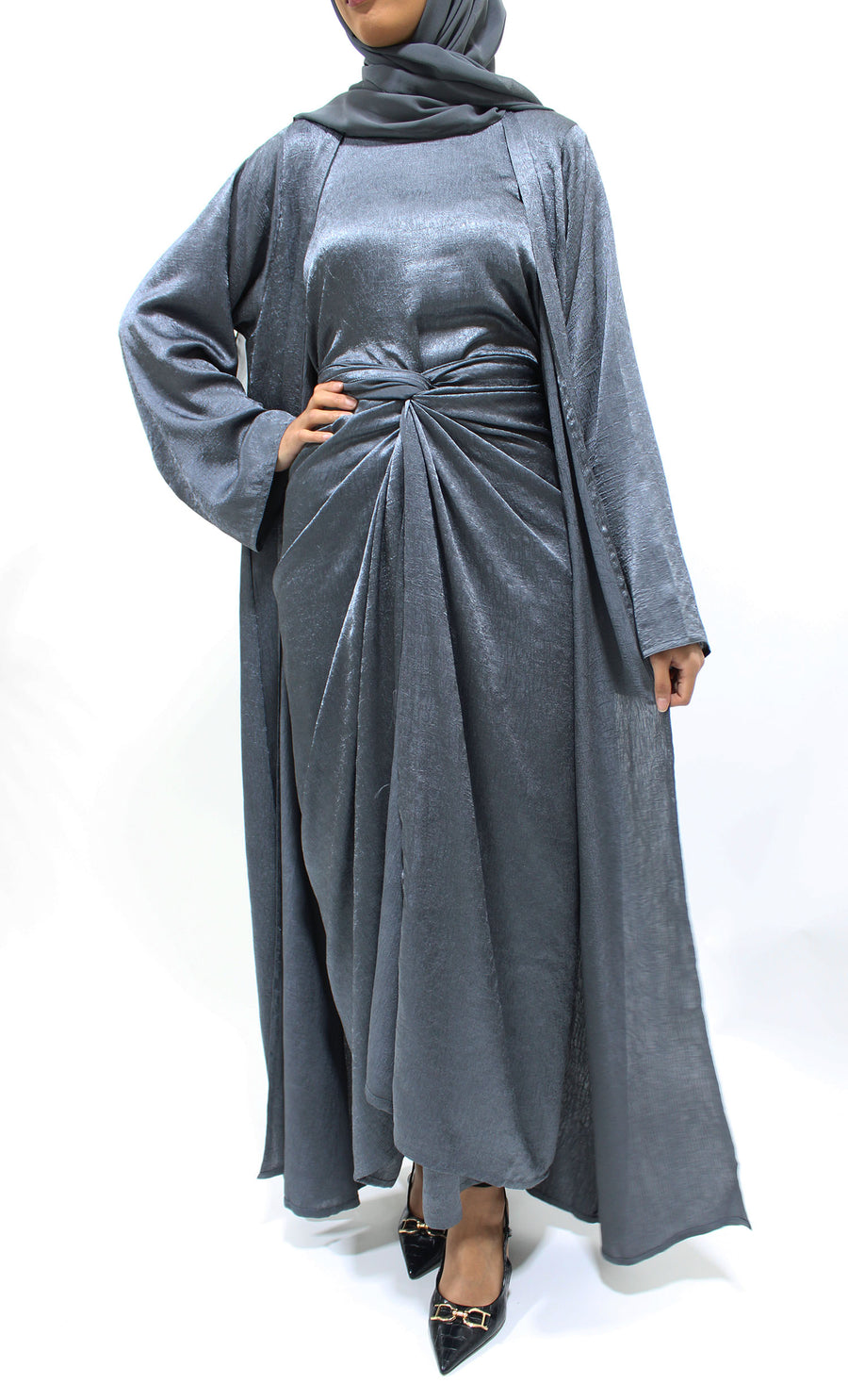 Side view of the cool grey crushed satin open abaya showing its soft modern sheen