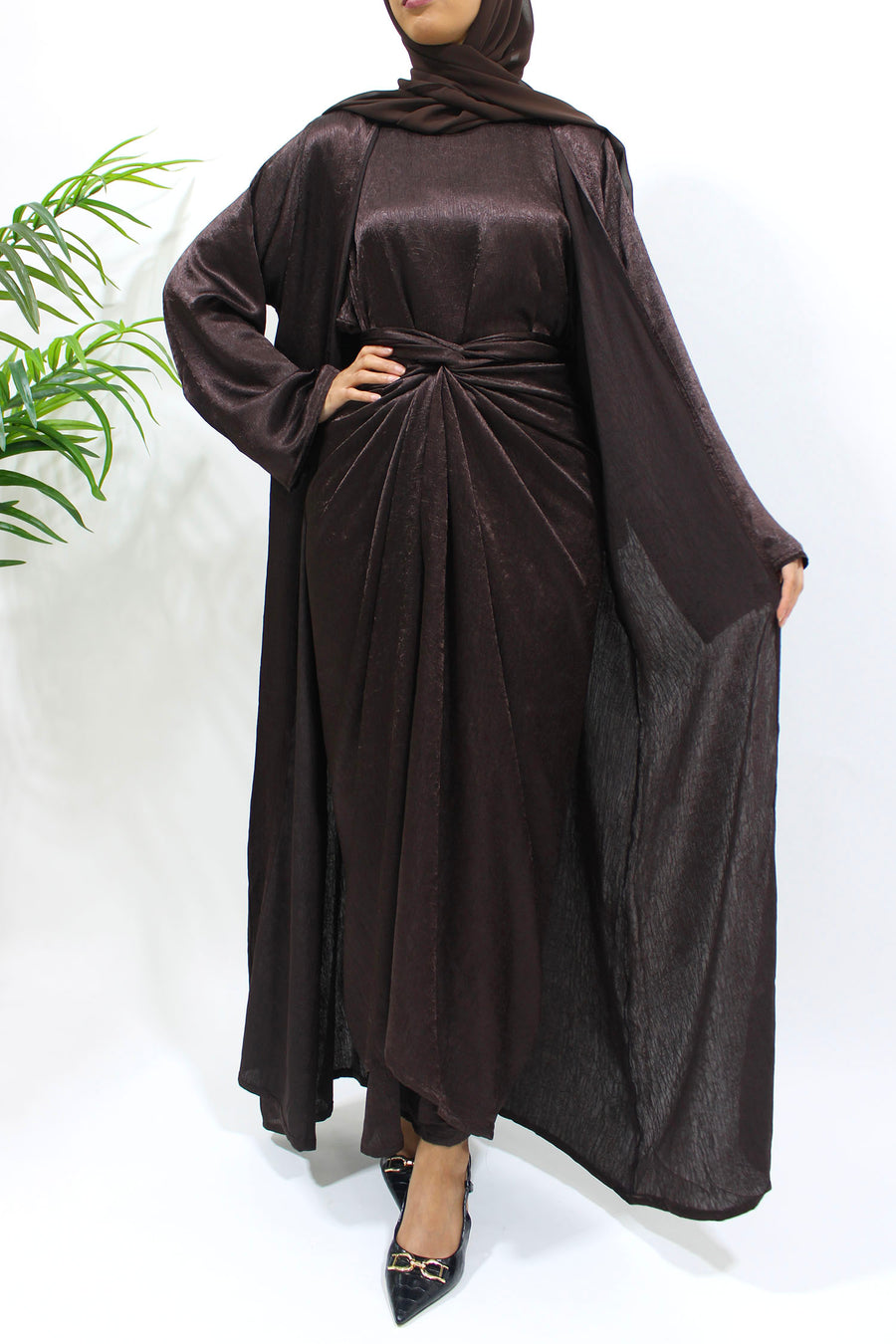 Side view of the dark brown crushed satin open abaya showing its warm textured sheen
