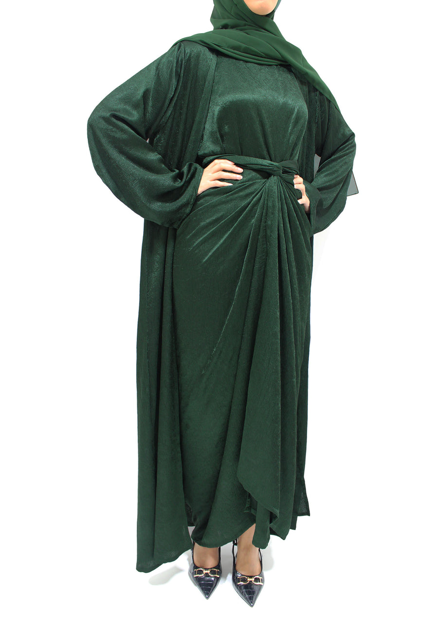 Side view of the forest green crushed satin open abaya showing its jewel-like textured sheen