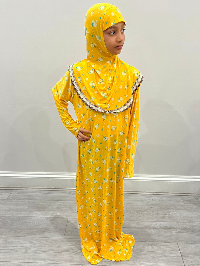 Little girl wearing Amani's Tuscany yellow one-piece slip-on prayer dress with attached hijab