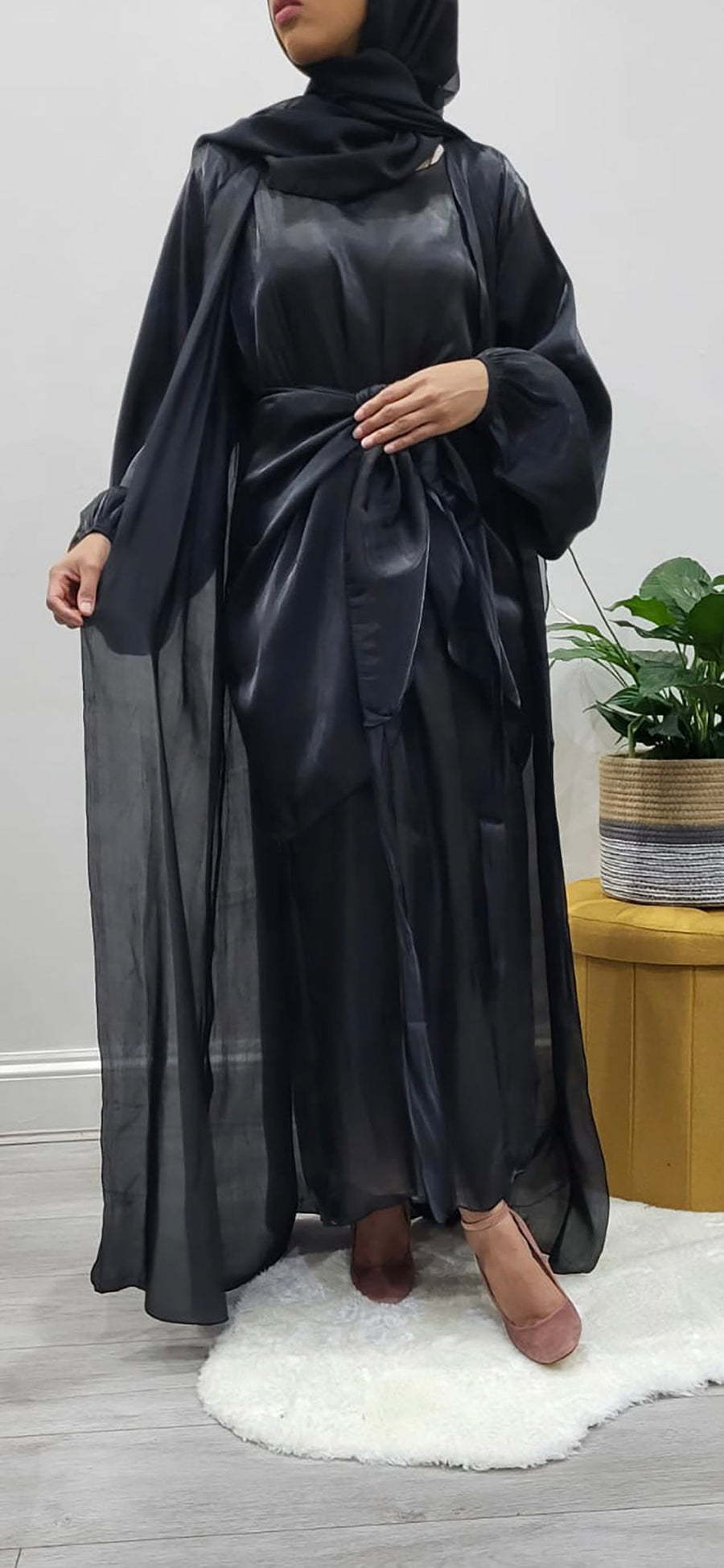 Close view of the hand-stitched embellishment on the black organza abaya