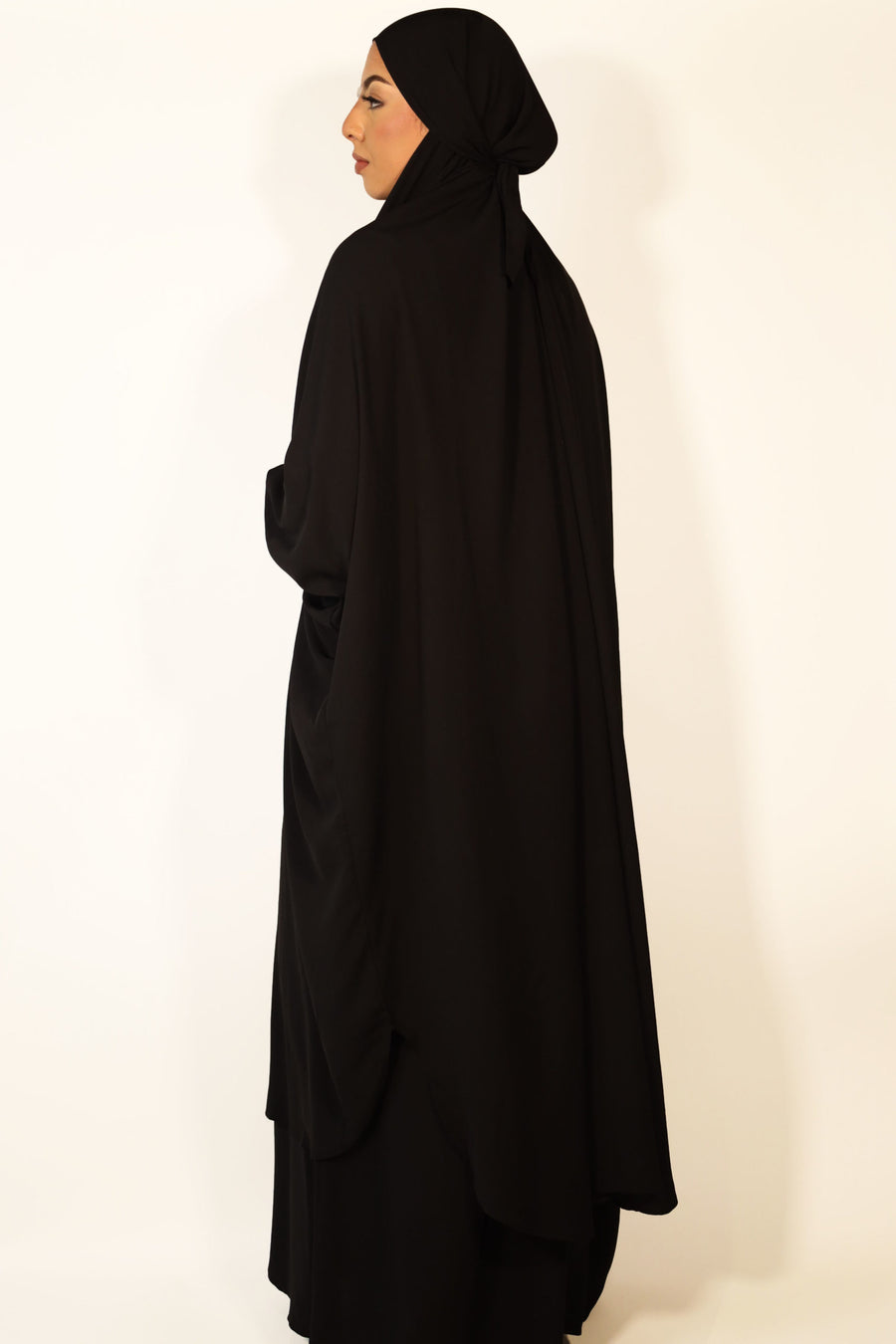 Black jilbab set showing the overhead top with longer back and ruched cuffs