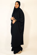 Black two-piece ruched cuffs jilbab set with overhead top and elasticated skirt, front view