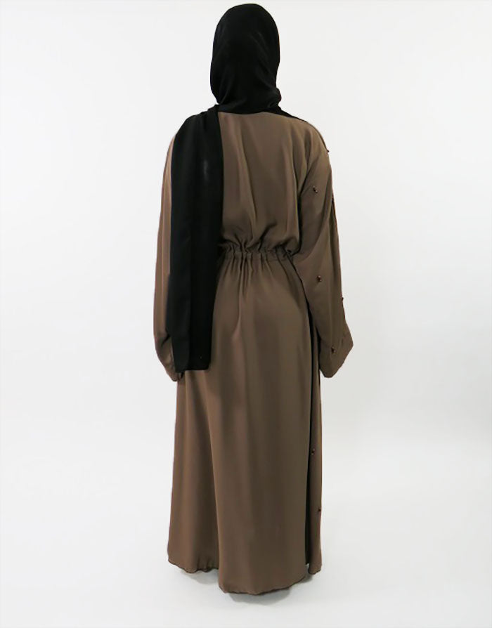Beaded Neda abaya showing wide sleeves and crossover panel