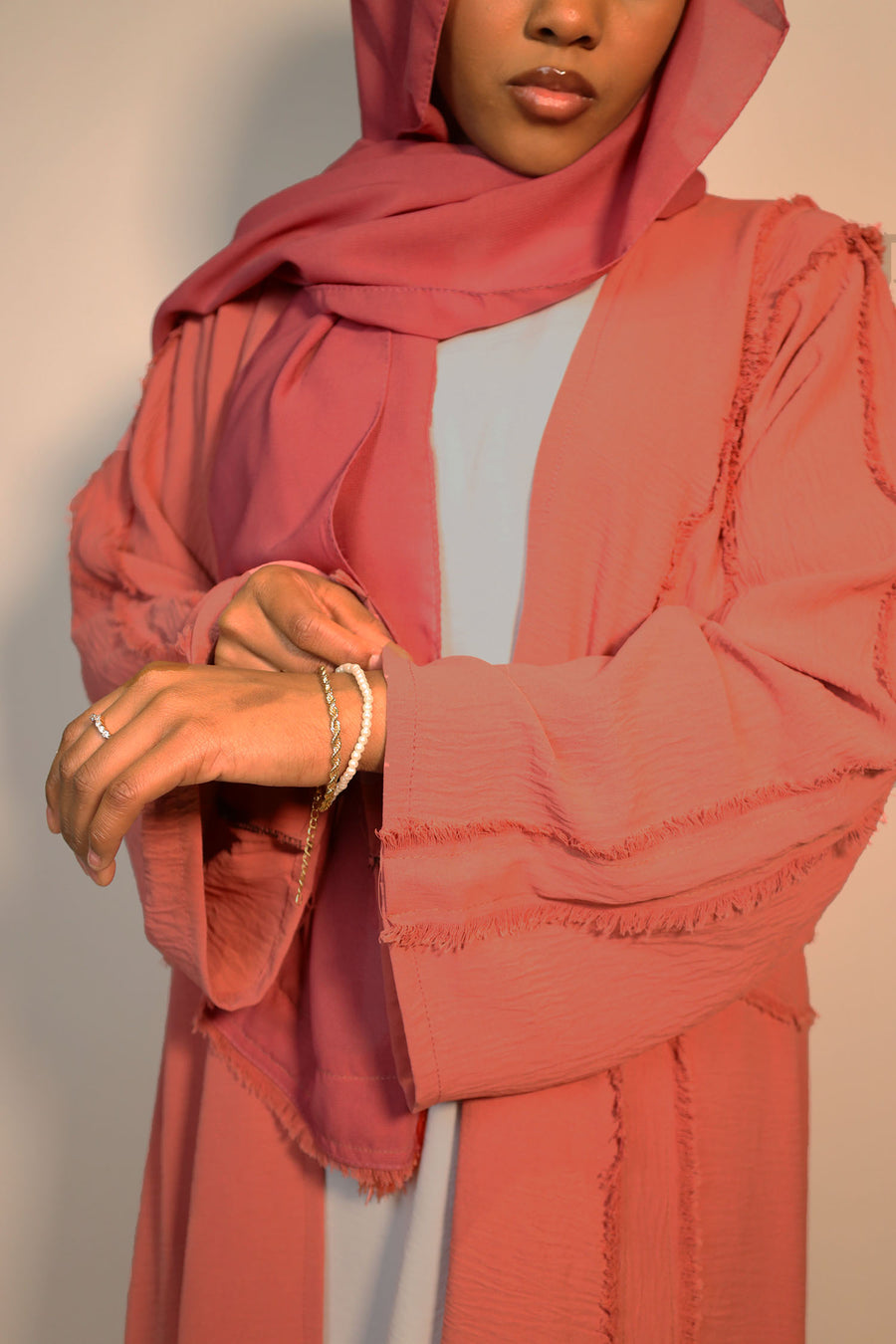 Dark salmon open abaya belted over its matching inner slip dress