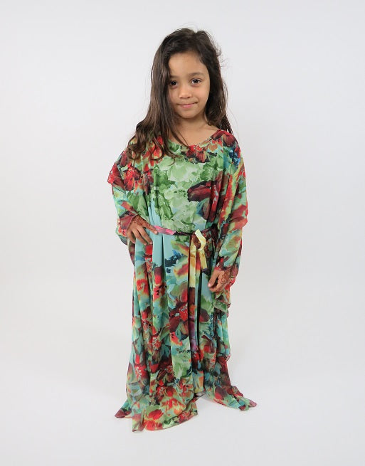 Girl wearing Amani's green floral print long-sleeve kids maxi dress with belt