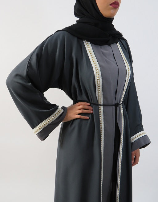 Close view of the pearl detailing on the grey two-tone abaya