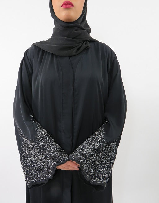 Detail of the silver lace embroidery on the abaya jacket hem and sleeves