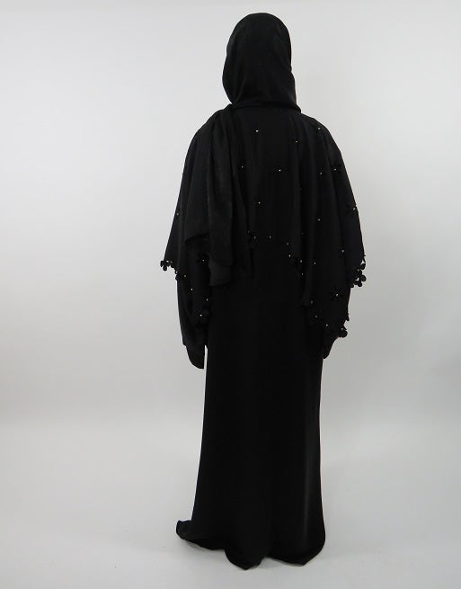 Beaded open abaya draped open over an outfit