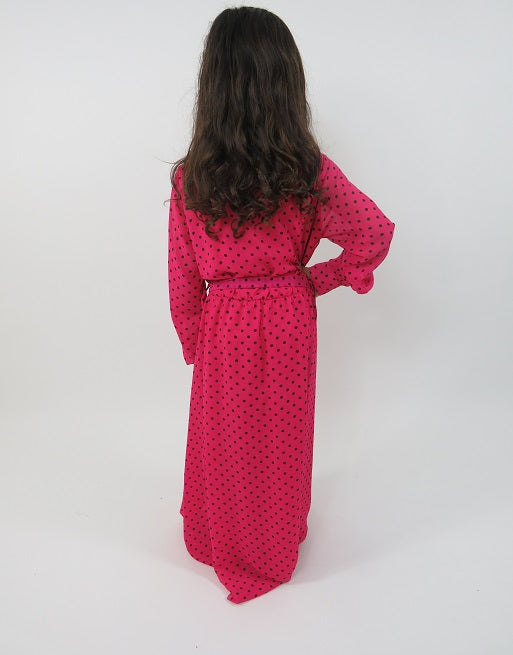 Full-length view of Amani's pink polka-dot kids maxi dress