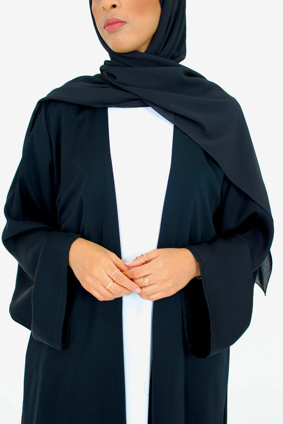 Black duster abaya shown with its matching scarf